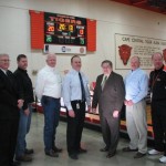 READY TO KEEP SCORE, (from left) Executive Vice President of the Electrical Connection Jim Curran, owners of Farmington-based Total Electric Rodney and Danny Miller, Cape Central Junior High School Assistant Principal Alan Bruns, Executive Vice President of the St. Louis Chapter of the National Electrical Contractors Association Doug Martin, IBEW Local 1 Business Representative Lee Asher and Cape Central Junior High School Athletic Director Terry Kitchen stand proudly before one of the new scoreboards donated by the Electrical Connection and installed by IBEW Local 1 skilled electricians. – Casey Communications photo 