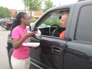 SUPPORTING FELLOW WORKERS: Olivia Roffle, an employee of Papa John’s, hands a leaflet to a would-be customer at Jimmy John’s in Soulard, urging the customer to demand Jimmy John’s pay its workers a living wage and treat them with respect. The customer, who asked that he not be named, bought his lunch elsewhere. Roffle was one of about 20 fast food workers who leafleted the store May 16 in support of Jimmy John’s workers as part of the fast food workers’ “St. Louis Can’t Survive on $7.35” campaign. Labor Tribune photo 