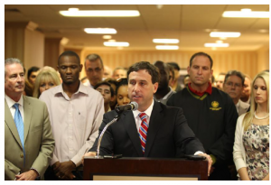 CAMPAIGN BEGINS: Steve Stenger (at podium), St. Louis County’s 6th District councilman, last week announced he will challenge incumbent County Executive Charlie Dooley in the Democratic primary next year. Among the many unions and their leadership at the announcement were (at left) District 4 Councilman Mike O’Mara, international representative of the United Association and member Plumbers & Pipefitters Local 562; at right, Mark Woolbright, International Association of Fire Fighters 2nd District vice president. The labor movement has announced it will not be supporting Dooley for re-election but has yet to make a formal endorsement. The St. Louis County Police Officers Association was the first to make a formal endorsement. 