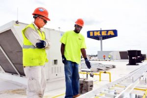 SOLAR ENERGY BENEFIT: Pat Wittich and Daniel Adkinson of Aschinger Electric place rails around solar panels on the roof of the new IKEA located in the St. Louis’ Cortex Innovation District. – Wiley Price/St. Louis American photo