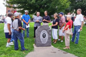 TIM DREA, secretary-treasurer of the Illinois AFL-CIO (center in gray jacket) and legislative candidate Mike Mathis (to the right of Drea) meet with retired coal miners and friends at the Christian County Coal Miners monument in Taylorville.